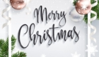 Merry Christmas inscription greeting. White festive background with holidays elements. Christmas tree branches, balls rose gold and serpentine. Calligraphic script. Lettering text. EPS10